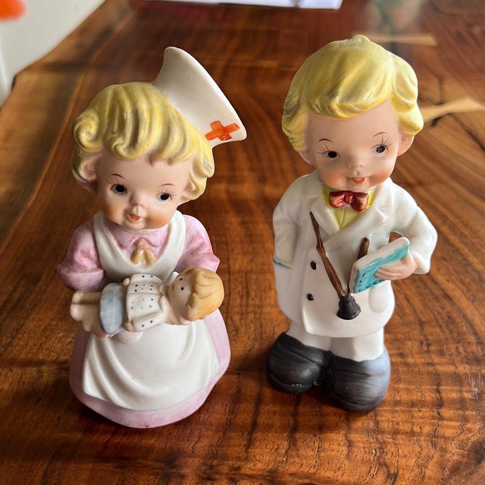 Vintage porcelain baby nurse with baby and boy doctor.